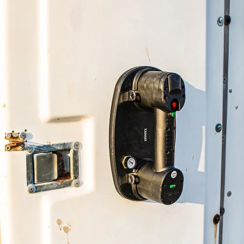Nemo GRABO vacuum lifter attached to a vertical white metal panel