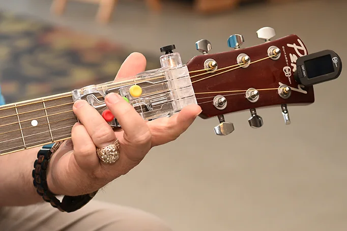 ChordBuddy guitar-learning attachment, associated with inventor Travis Perry