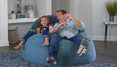 Byron Young seated in a CordaRoy's bean-bag chair bed