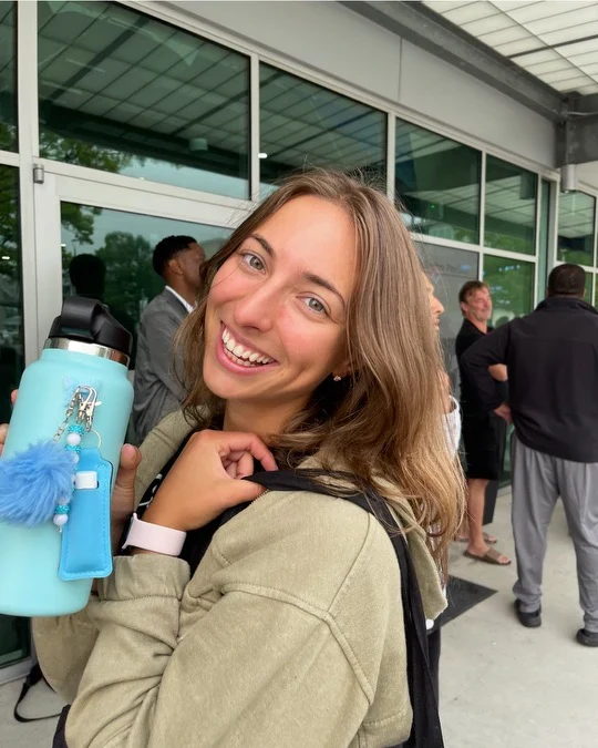 Charlotte Trecartin holding a CharCharms water bottle