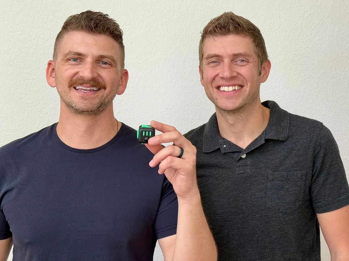Matthew and Mark McLachlan holding the original Fidget Cube
