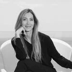Vicki von Holzhausen seated in a white chair