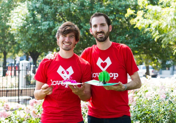 Wombi Rose and John Wise holding Lovepop cards
