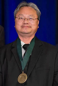 Yasha Yi wearing his National Academy of Inventors medal